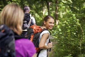 people hiking with one woman looking at viewer over her shoulder