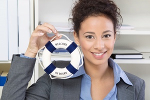 Woman holding small life preserver that says welcome on board